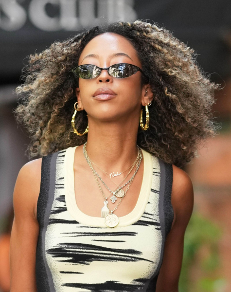 Woman in sunglasses and yellow and black tank top